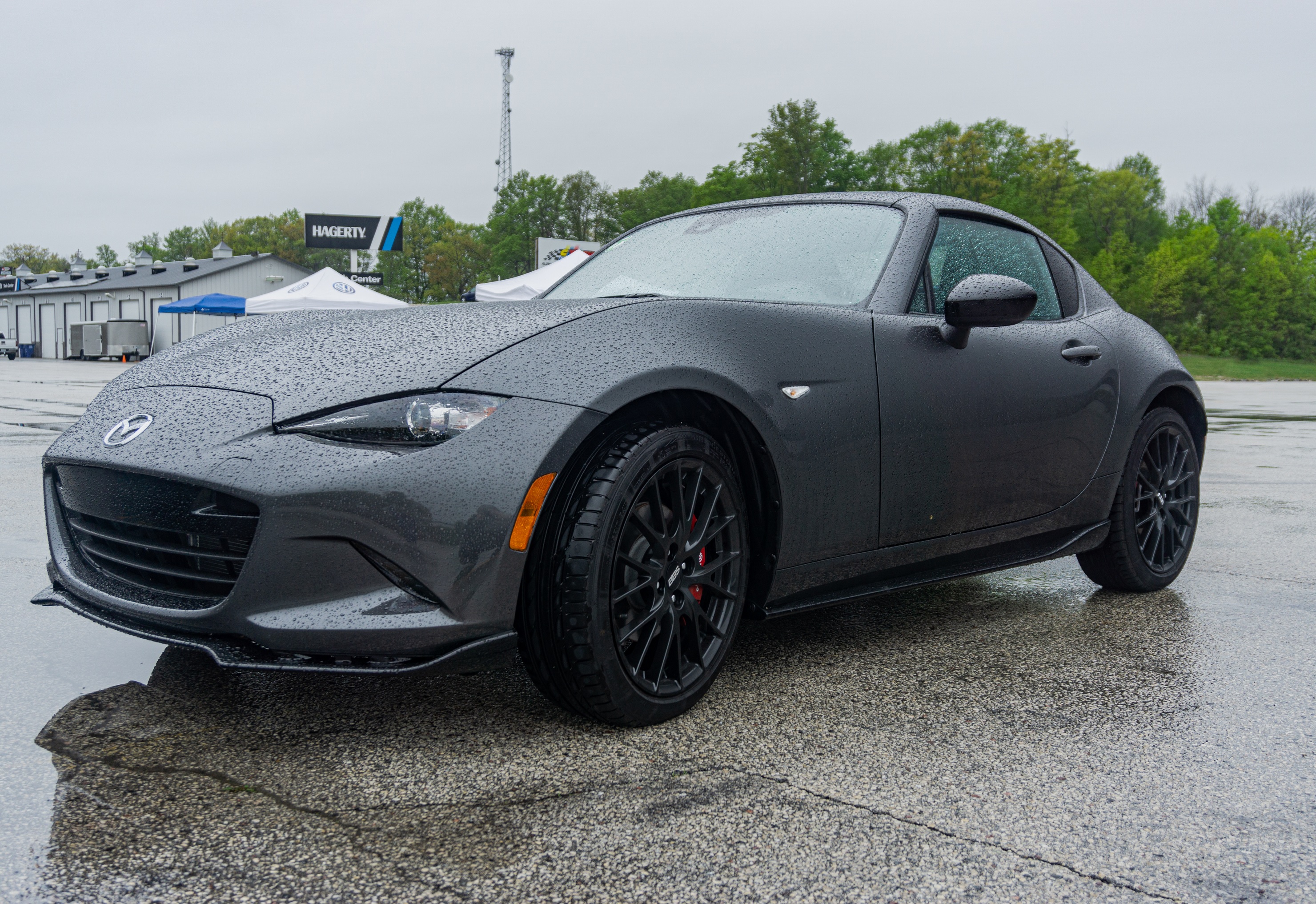 A gray 2022 Mazda MX-5 Miata RF Club in a racetrack parking lot