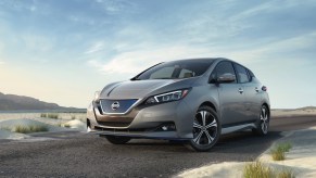 a new nissan leaf parked on a beach, a great long haul electric car