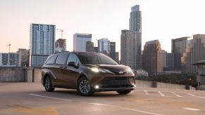 A black 2022 Toyota Sienna in front of a city skyline.