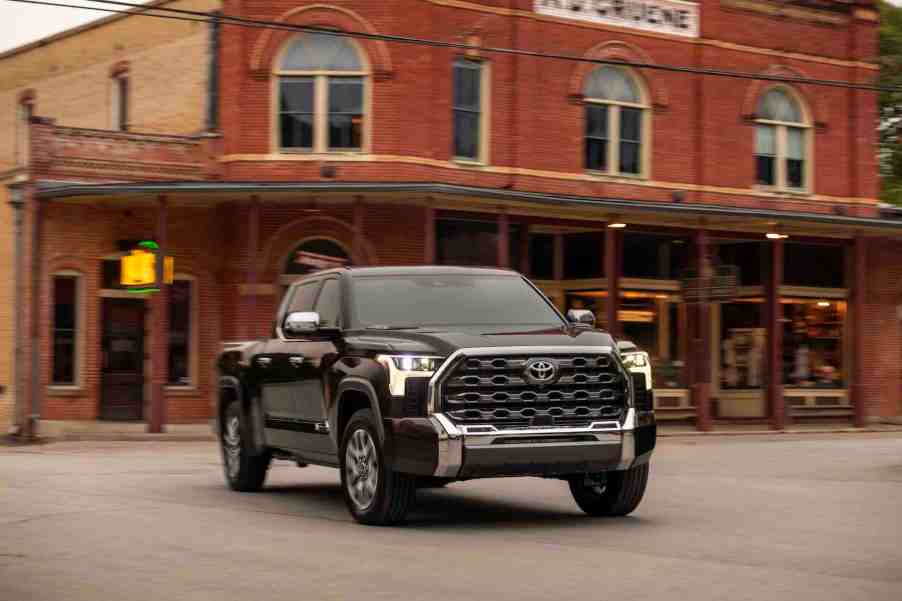 A dark colored 2022 Toyota Tundra in front of a building.