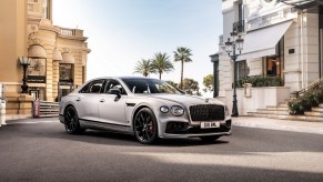 A silver-gray 2023 Bentley Flying Spur S in a European city square