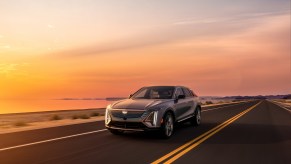 A gray 2023 Cadillac Lyriq driving down a highway.