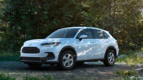 A white 2023 Honda HR-V subcompact SUV is parked outside in the shade.