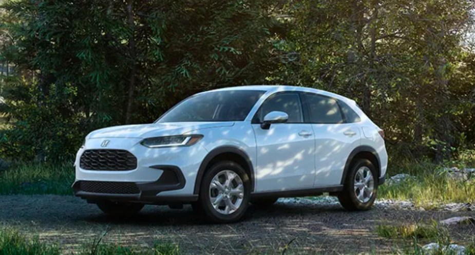 A white 2023 Honda HR-V subcompact SUV is parked in the shade. 