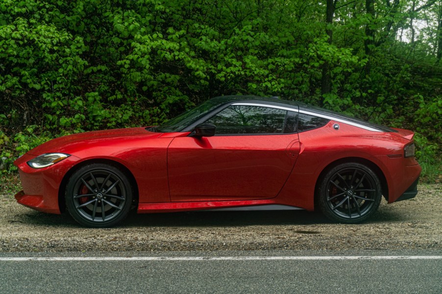 The side view of a red 2023 Nissan Z Performance in a forest