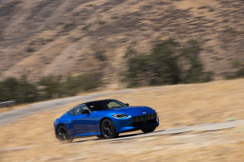 2023 Nissan Z driving by a field