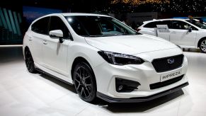 White Subaru Impreza hatchback at an auto showThe S