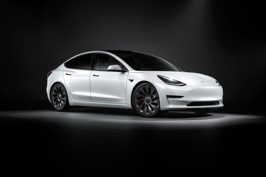 White Tesla Model 3 luxury electric car set against a dark background