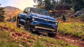 blue chevy silverado EV truck in teh woods