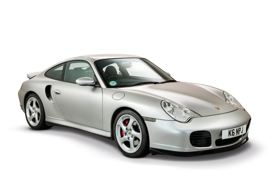 A silver 996 Porsche 911 Turbo Coupe in a white studio