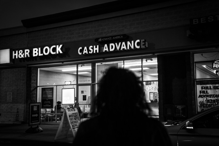 A car owner walking to a loan agency to get her repossessed car back