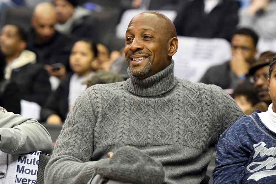 Alonzo Mourning, who did a stint at a Pontiac dealership, wearing a grey sweater sitting in a crowd.