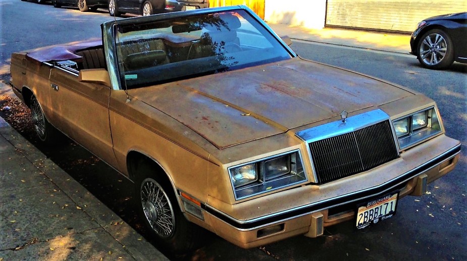 Chrysler LeBaron convertible parked under a tree 