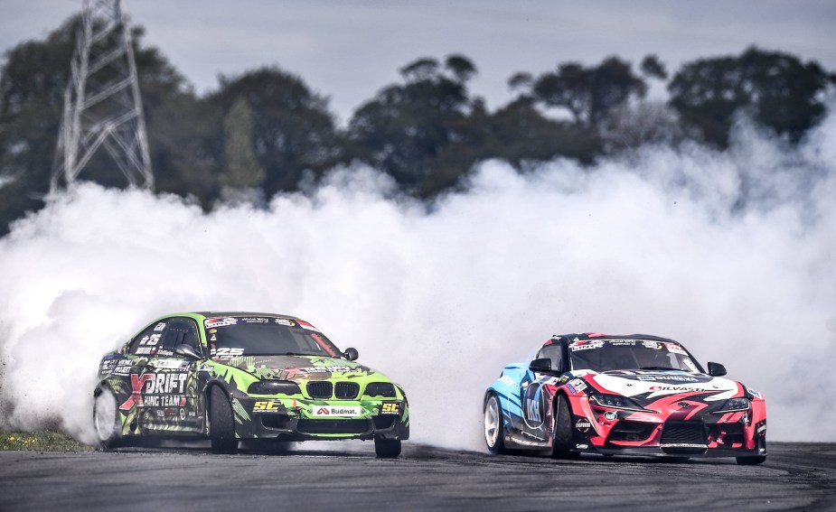 Two cars drifting practicing over and understeer potentially on a track.