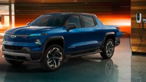 A blue 2024 Chevy Silverado EV RST is charging.