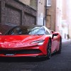 Red Ferrari SF90 Stradale parked near brick wall, similar to the one crashed in U.K.