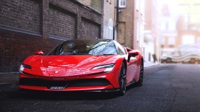 Red Ferrari SF90 Stradale parked near brick wall, similar to the one crashed in U.K.