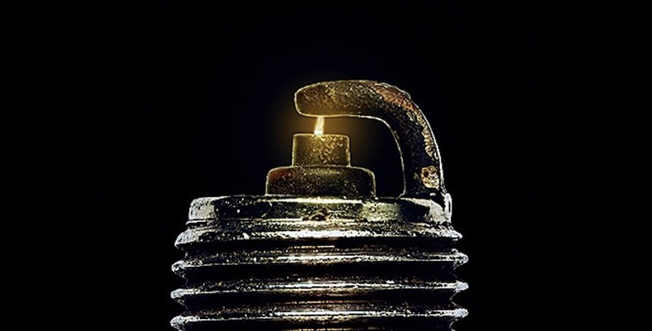 Closeup of a spark jumping between a spark plug's electrodes.