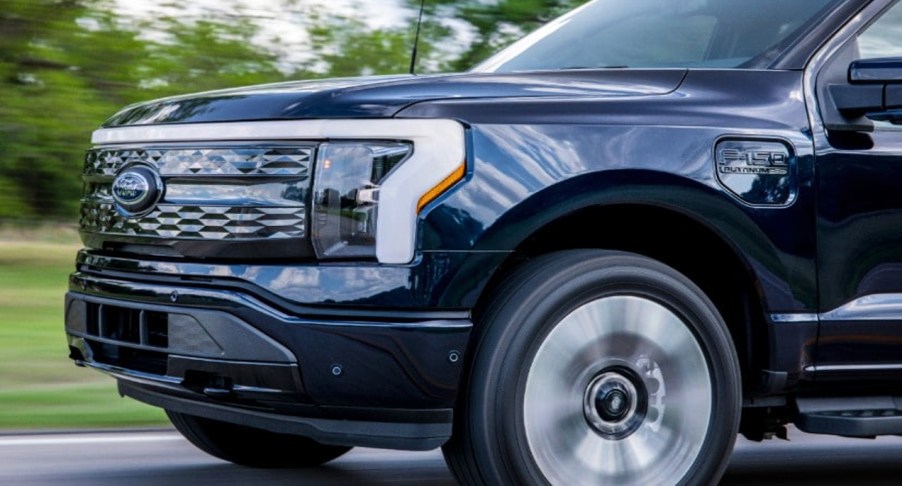 The front of a black 2022 Ford F-150 Lightning Platinum electric pickup truck.