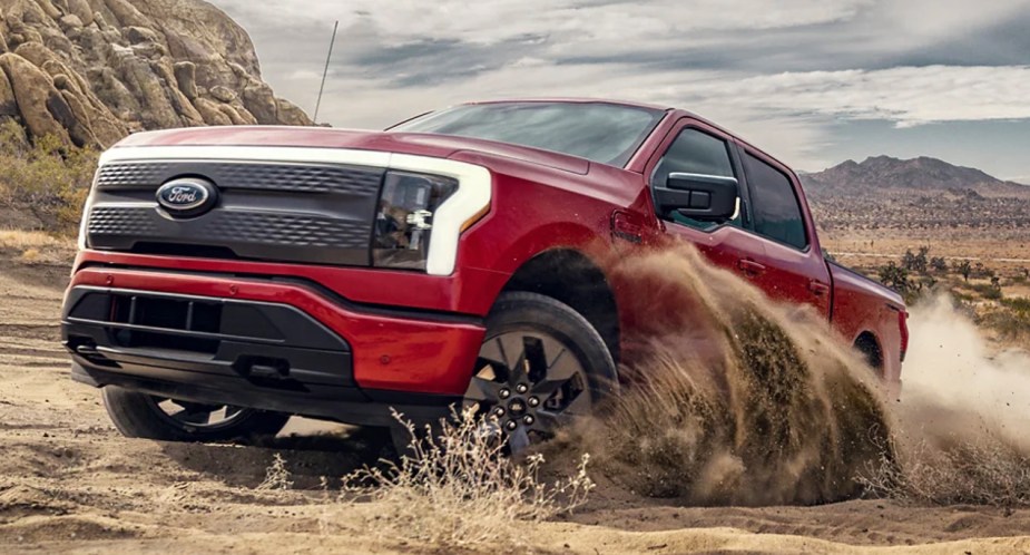 A red 2022 Ford F-150 Lightning electric pickup truck. 