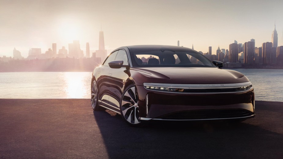 Front angle view of maroon Lucid Air, a good alternative to a Tesla for EV buyers that hate Elon Musk