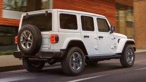 A white 2022 Jeep Wrangler navigates an area road.