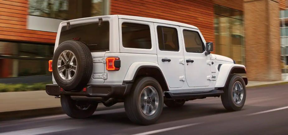 A white 2022 Jeep Wrangler navigates an area road.