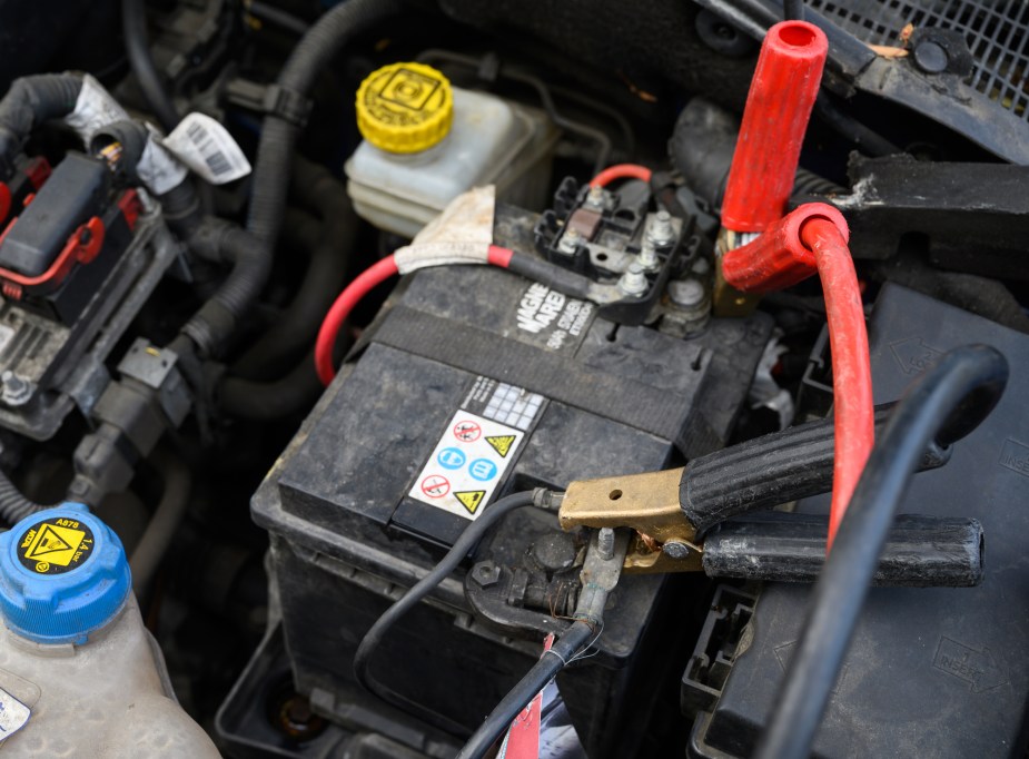 A set of jump starters jump starting a vehicle.