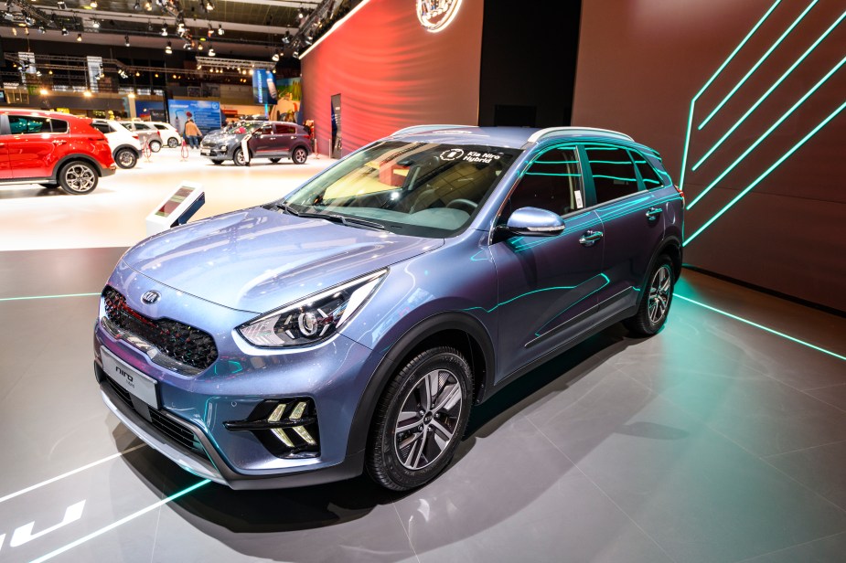 A sky blue Kia Niro parked indoors. 