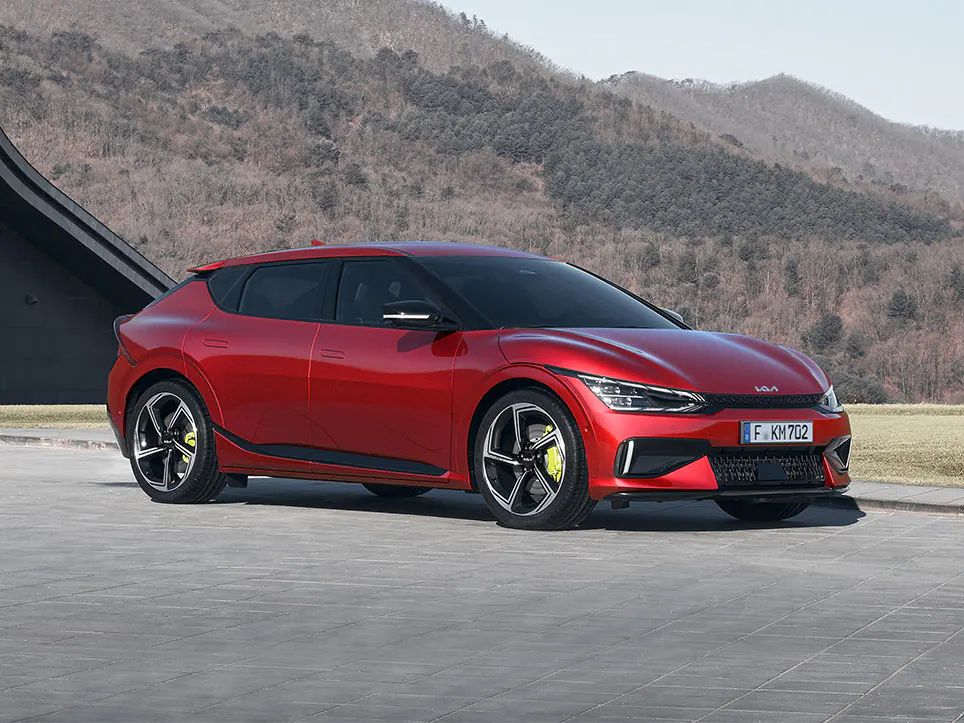 A red Kia EV6 GT shows off its styling as a performance electric SUV.