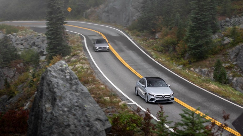 two different mercedes benz a class sedans driving along a road, the top compact luxury sedan that offers you most performance