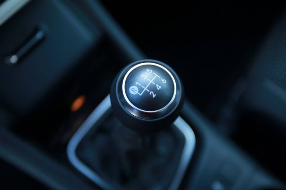 Manual transmission stick shift in black.