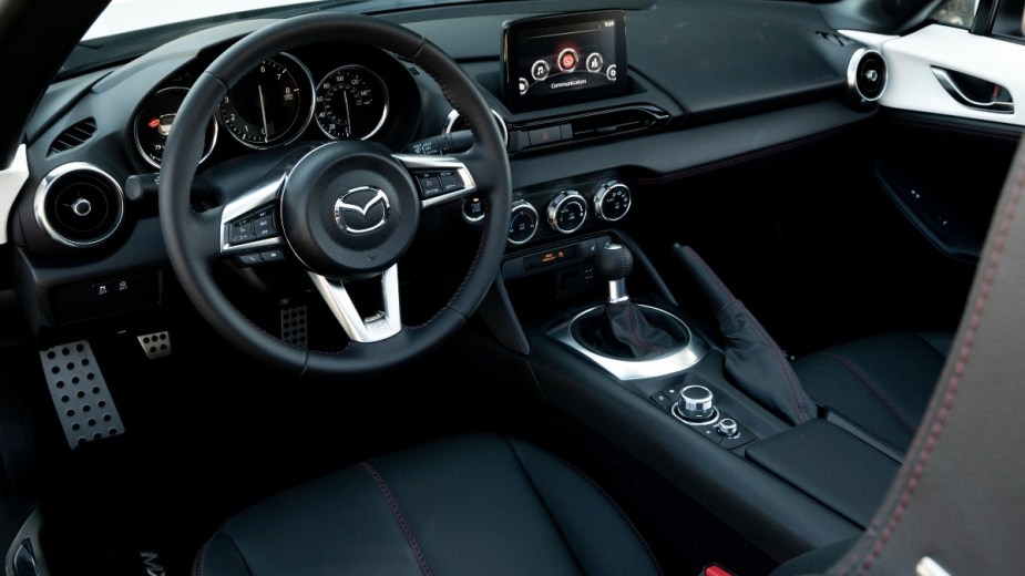 the modern interior of a mazda mx 5 miata, a cramped interior for tall drivers