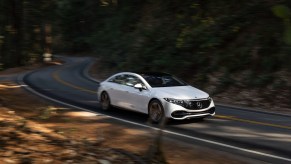 a new 2022 mercedes benz mercedes eq eqs driving along a winding road, the top new luxury electric car with its performance and luxury