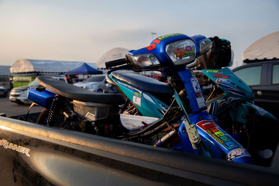 A motorcycle in the back of a truck bed.