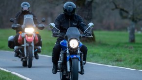 Two motorcycle riders making their way down the highway.