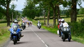 A group of motorcycles riding burn calories on a highway.