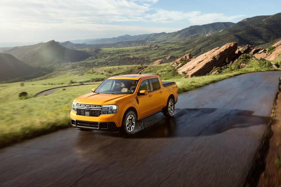 Orange 2022 Ford Maverick, which could be challenged by new Toyota compact pickup truck, driving on a mountain road