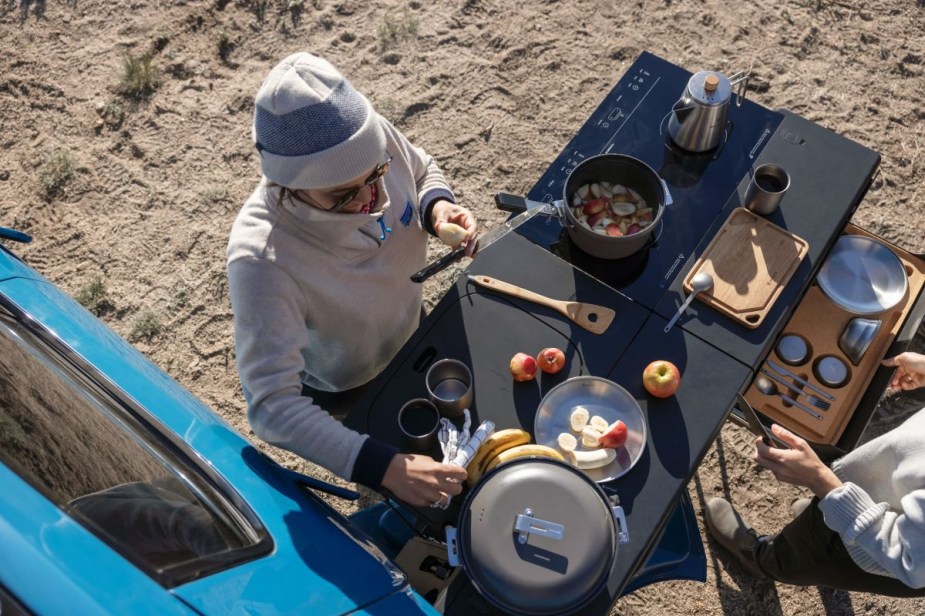 Overhead view of camp kitchen, which slides out of the gear tunnel in the 2022 Rivian R1T electric pickup truck