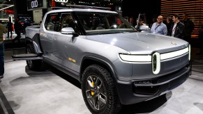 A silver Rivian R1T parked indoors.