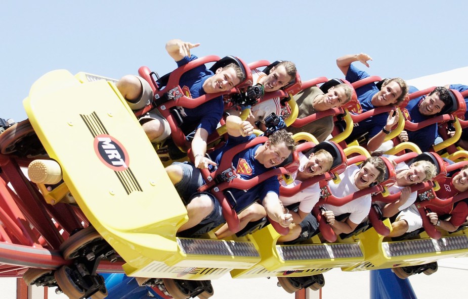 A roller coaster with people on it. 