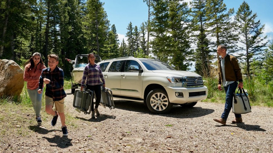 People standing around a white 2022 Toyota Sequoia.