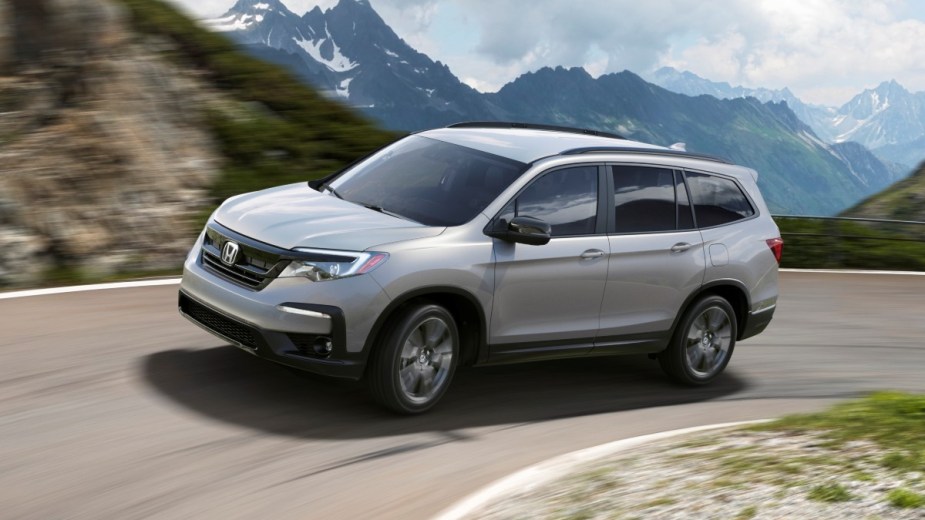 Silver 2022 Honda Pilot driving on a mountain road