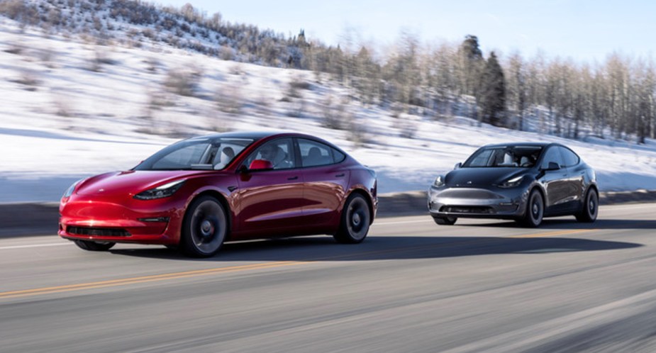 A Tesla Model Y electric SUV is driving on the road. 