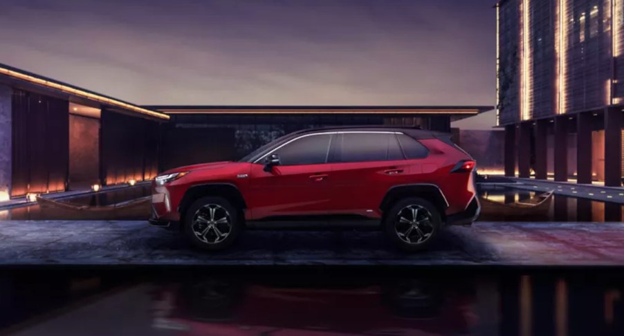 A red 2022 Toyota RAV4 Prime plug-in hybrid SUV is parked outdoors.