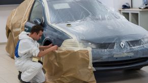 An apprentice applying paint protection to a Renault car as a dealer option