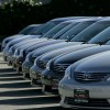 A man inspects new Toyota cars on display.