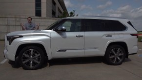 Doug DeMuro standing behind a white 2023 Toyota Sequoa