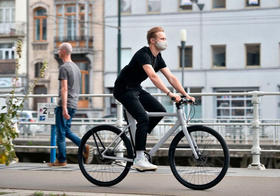 A man rides a Cowboy electric bike.