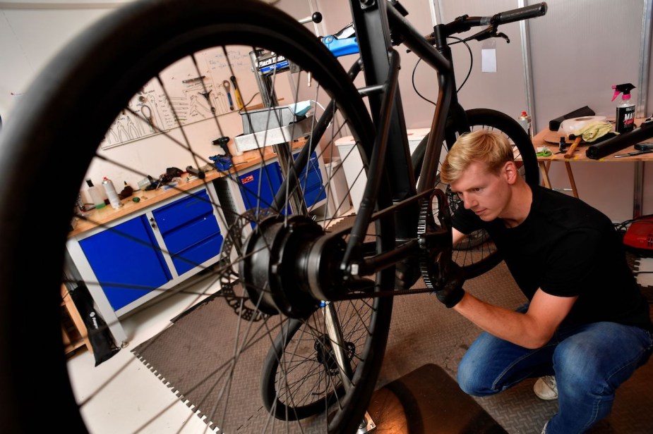 A mechanic works on a Cowboy electric bike